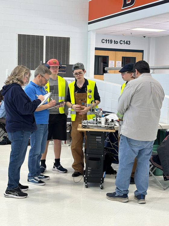 James explaining the 22370 robot to judges